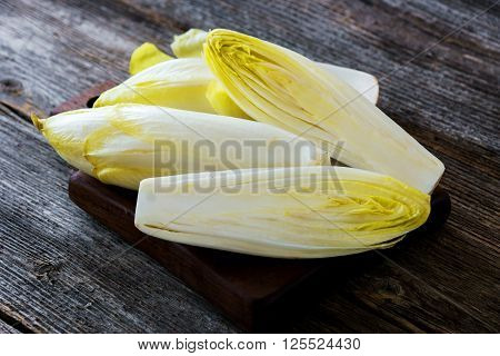 Fresh Chicory Salad  On  Rustic Wooden Table.