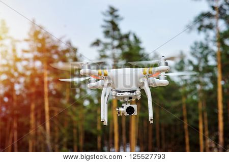 Irpen, Ukraine - April 11, 2016: drone flying on a background of forest trees.