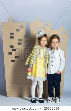 Love concept. Couple of kids. boy and girl with  cardboard town.