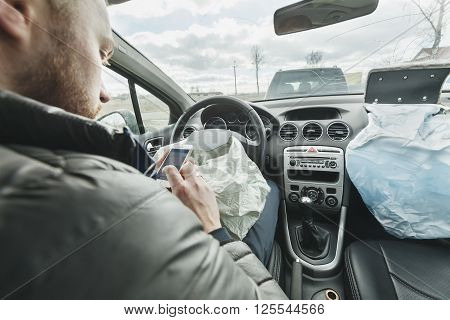The man was in a car accident, shot airbag. The driver dials the phone number of service of rescue