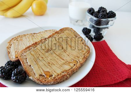 Toasted bread with sesame tahini and honey on a tablecloth. Breakfast concept