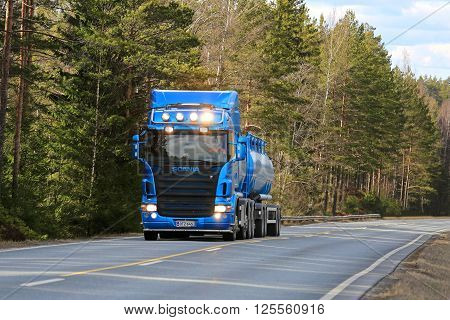 SALO, FINLAND - APRIL 10, 2016: Blue Scania R500 tank truck moves uphill flanked by forest in South of Finland. Scania celebrates 125 years in 2016.