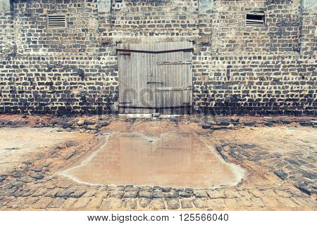 wall of ancient wooden barn with door