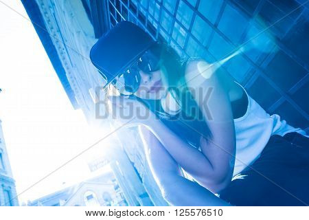 A beautiful young Hip Hop Rapper girl with Headphones in a urban environment.
