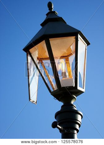 Broken street lamp burning during the day as a symbol of waste
** Note: Visible grain at 100%, best at smaller sizes