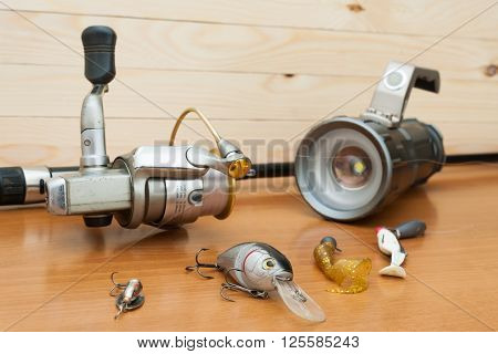 a set of fishing equipment on a wooden background