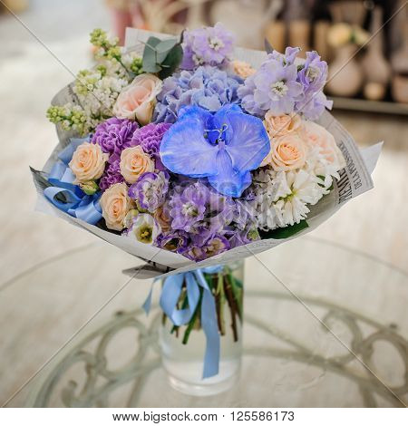 Bouquet of white and blue flower on table