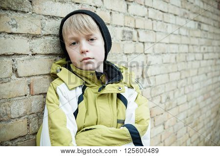 Child In Coat With Dejected Expression