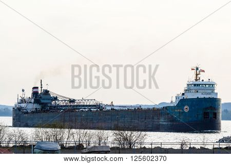 HAMILTON CANADA - MAY 11 2014: The self unloading Great Lakes bulk freighter Algosoo leaves Hamilton Harbour at the western end of Lake Ontario.