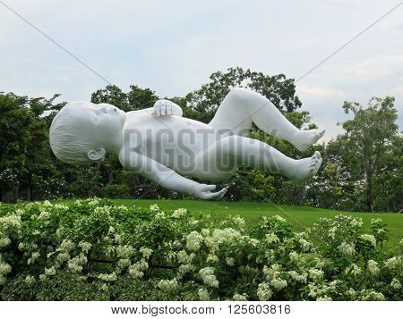 SINGAPORE ASIA -  NOVEMBER 22:  Marc Quinn's Planet, a giant sculpture of a sleeping baby suspended in mid-air Gardens by the Bay nature park November 22, 2014 in Singapore Bay Marina, Asia