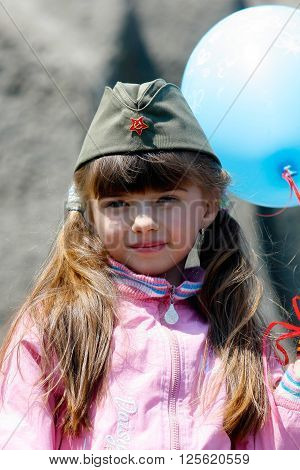 Volgograd, Russia - May 9 2008: A little girl in a military garrison cap on Victory Day celebration on Mamaev hill in Volgograd