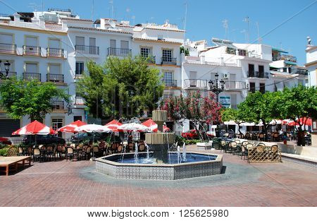 TORROX, SPAIN - JULY 1, 2008 - Fountain and pavement cafes in the town square Torrox Malaga Province Andalucia Spain Western Europe, July 1, 2008.