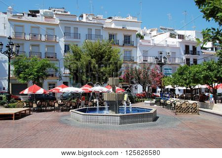 TORROX, SPAIN - JULY 1, 2008 - Fountain and pavement cafes in the town square Torrox Malaga Province Andalucia Spain Western Europe, July 1, 2008.