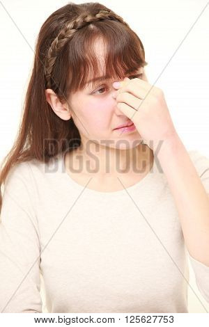studio shot of young woman suffers from Asthenopia