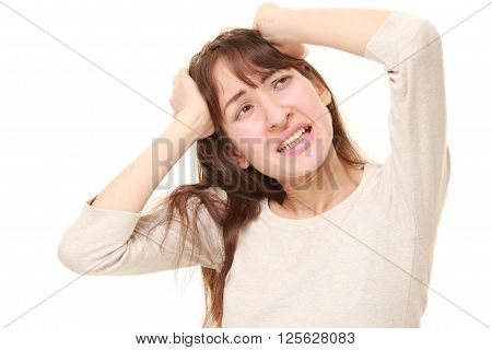 studio shot of perplexed woman on white background