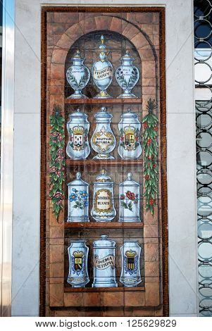 TORROX, SPAIN - JULY 1, 2008 - Ceramic tiled picture outside chemist shop illustrating assorted potions Torrox Malaga Province Andalucia Spain Western Europe, July 1, 2008.