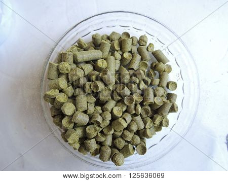 Granulated hops in the transparent glass container