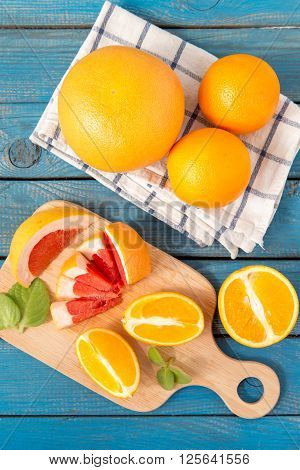 Fresh Oranges And Grapefruit On Wooden Background