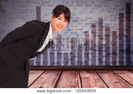 Smiling businesswoman bending against blue data