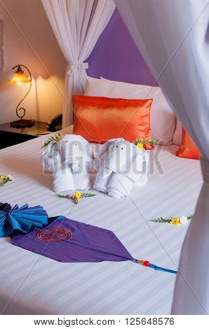 Elephant origami towel on the bed of a hotel.