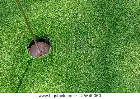 Golf hole on green with artificial grass in Phuket Thailand