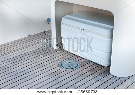 White box storage on a boat wooden floor