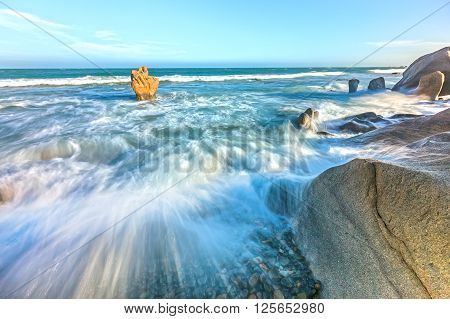 Raging waves hitting reefs create waves splashing up high and dangerous but very beautiful watch, blue sea attracting tourists to resort in central Vietnam coast
