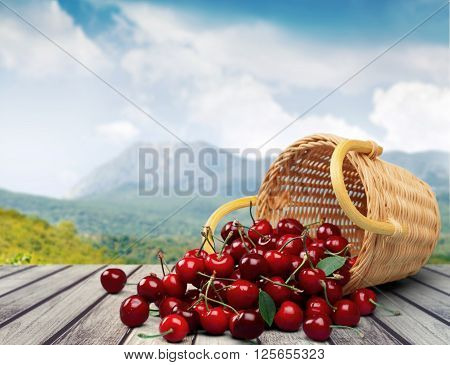 Red cherries in busket  isolated on  background