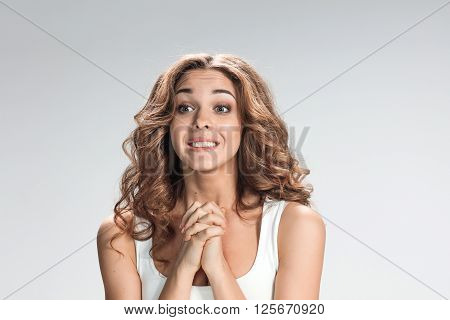 The Woman is looking imploring  over gray background