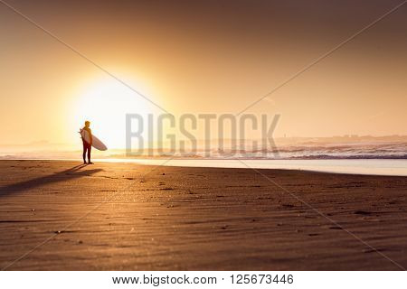 Beautiful beach lansdscape with surfers ready to hit the waves