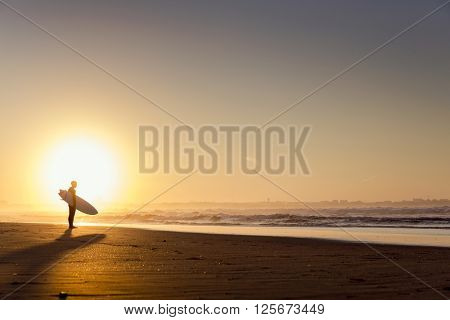 Beautiful beach lansdscape with surfers ready to hit the waves