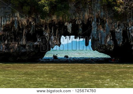 Tourists canoeing passing throgh the cave at Phang nga bay Thailand