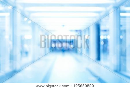 abstract defocused blurred background empty business corridor or shopping mall. Medical and hospital corridor defocused background with modern laboratory (clinic)