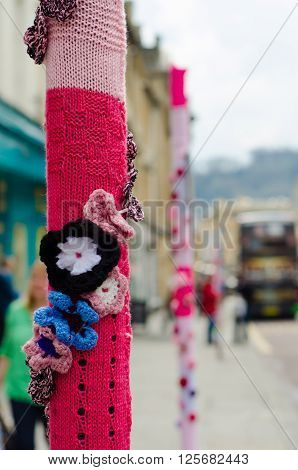 BATH SOMERSET UK - APRIL 14 2016 
Yarn bombing. An organised group cover poles and posts with knitting using wool to brighten up Milsom Street in the city centre