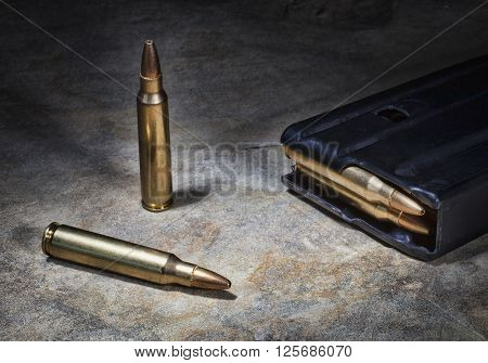 Ammunition for a semi automatic rifle on a rock with a magazine