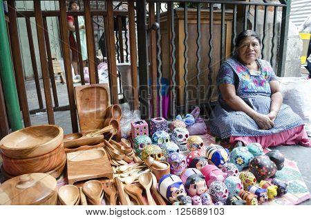 OAXACA MEXICO- MARCH 21, 2016: Woman posing with typical handicraft in a market in Oaxaca, Mexico