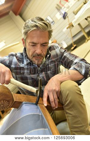 Man working in upholstery workshop