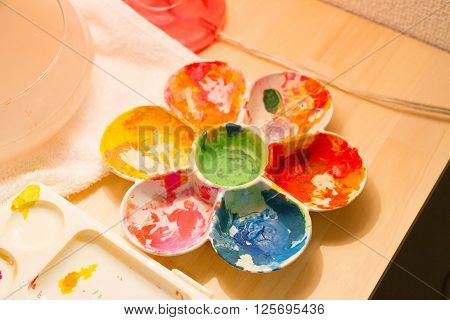 a color palette on table with happy