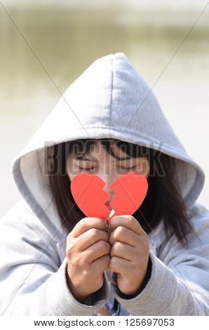 Sad Girl Praying to Reconcile with Red Broken Heart Shape