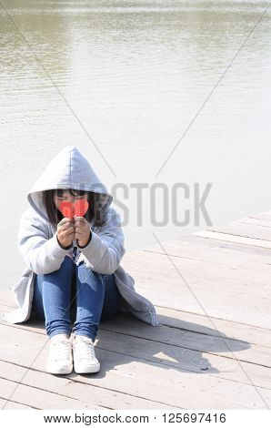 Sad Girl Praying to Reconcile with Red Broken Heart