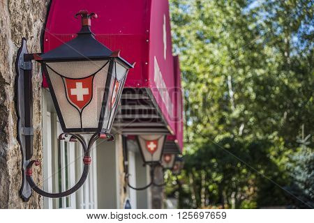 Vail, USA - September 10, 2015: Row of lanterns or lamps with Swiss Decoration and Logo on the buildings of Swiss Chalet restaurant in Vail, Colorado