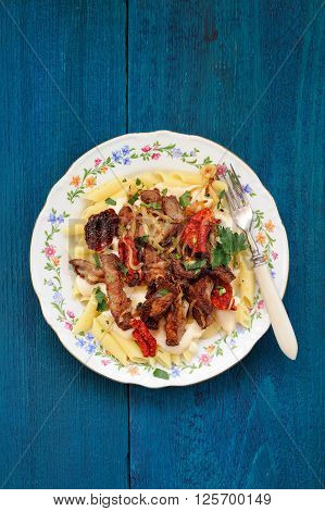 Stewed beef meat with Bechamel sauce and penne pasta vertical