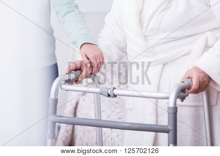 Close up of disabled person holding walking zimmer