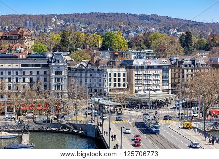 Zurich, Switzerland - 11 April, 2016: pedestrians and traffic on Quaibruecke bridge and Bellevue square view from the Ferris wheel temporarily installed on Burkliplatz square. Zurich is the largest city in Switzerland.