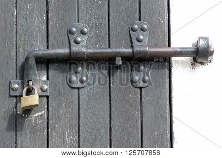 Old latch and padlock on wodeen door