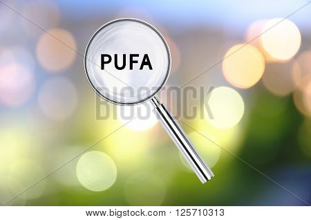 Magnifying lens over background with text PUFA, with the blurred lights visible in the background.