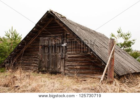 Old cottage old wooden house with moss among trees