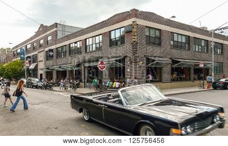Brooklyn New York - August 17 2014: Vintage car and pedestrians before drink bar at Greenpoint