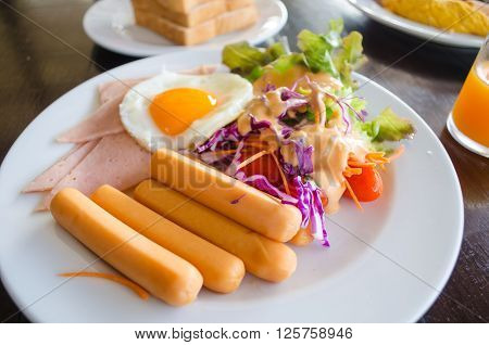 breakfast with hotdog fried egg and salad