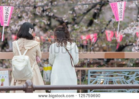 Tokyo Japan - April 7 2016: Japanese girls see beauty of Cherry blossom or Sakura at Meguro Canal in Tokyo Landmark see of cherry blossom season.